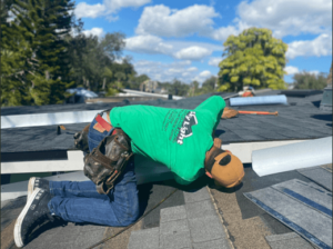 Professional roofer patching a leak on a roof